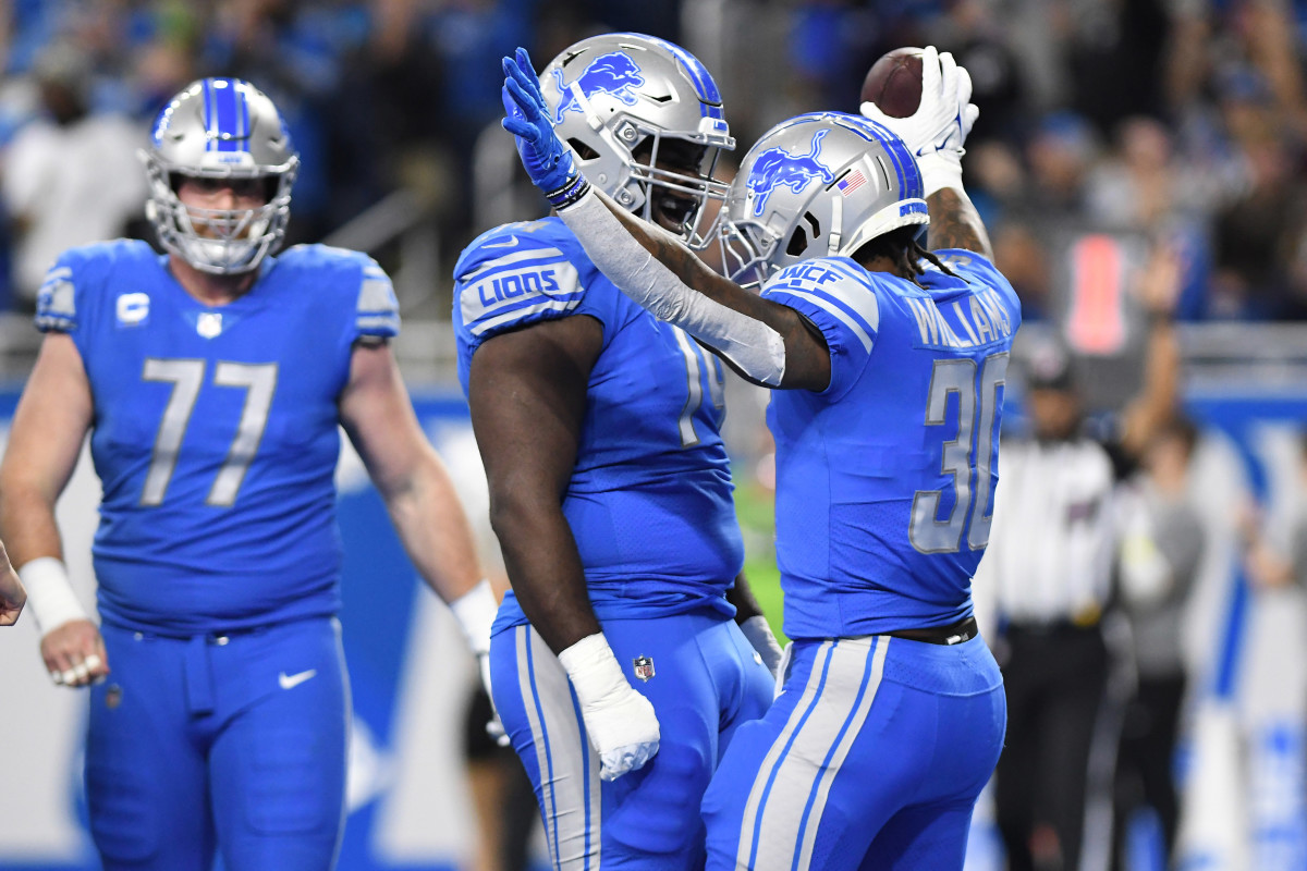 Detroit Lions running back Jamaal Williams celebrates with guard Kayode Awosika